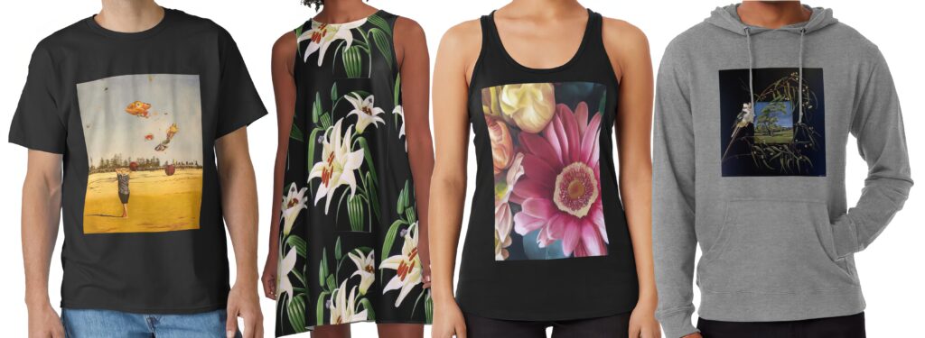 Collection of apparel featuring artworks by South Australian artist Avril Thomas on Redbubble: black t-shirt with surreal beach scene of a girl releasing flying fish balloons, sleeveless dress with elegant white lilies on dark background, black tank top with vibrant close-up floral painting of roses and gerbera daisy, and grey hoodie with detailed bird perched on eucalyptus branches against a blue sky landscape.